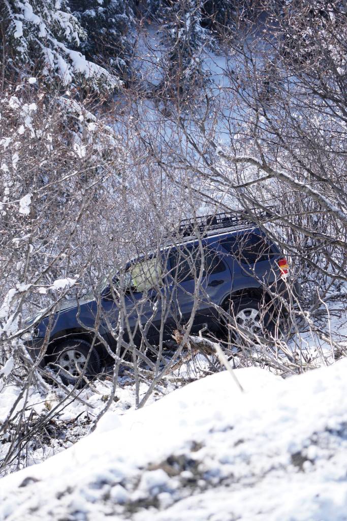 A sport utility vehicle rests in alders after it over the edge of Diamond Ridge Road on Monday morning, April 22, 2019, in Homer, Alaska. The SUV failed to make a turn heading south and went down the side of a stretch of road known by locals as Becks Hill. No one was injured in the crash. (Photo by Michael Armstrong/Homer News)