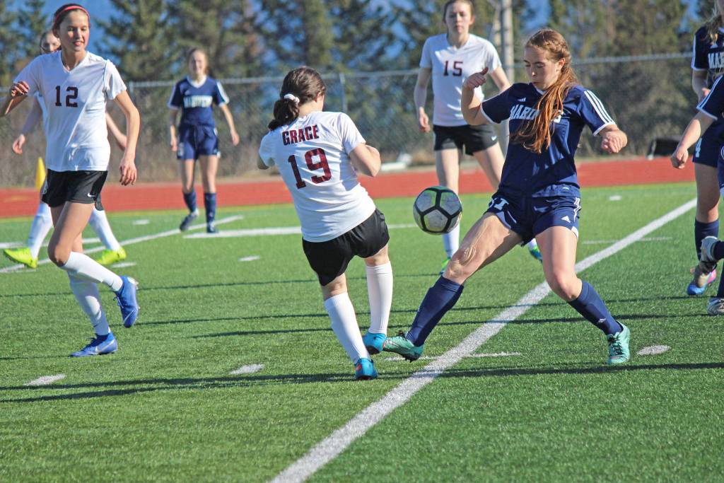 Mariner Summer McGuire has no intention of giving up control of the ball during Fridays varsity soccer game against Grace Christian on April 26, 2019, at the high school in Homer, Alaska. (Photo by McKibben Jackinsky)