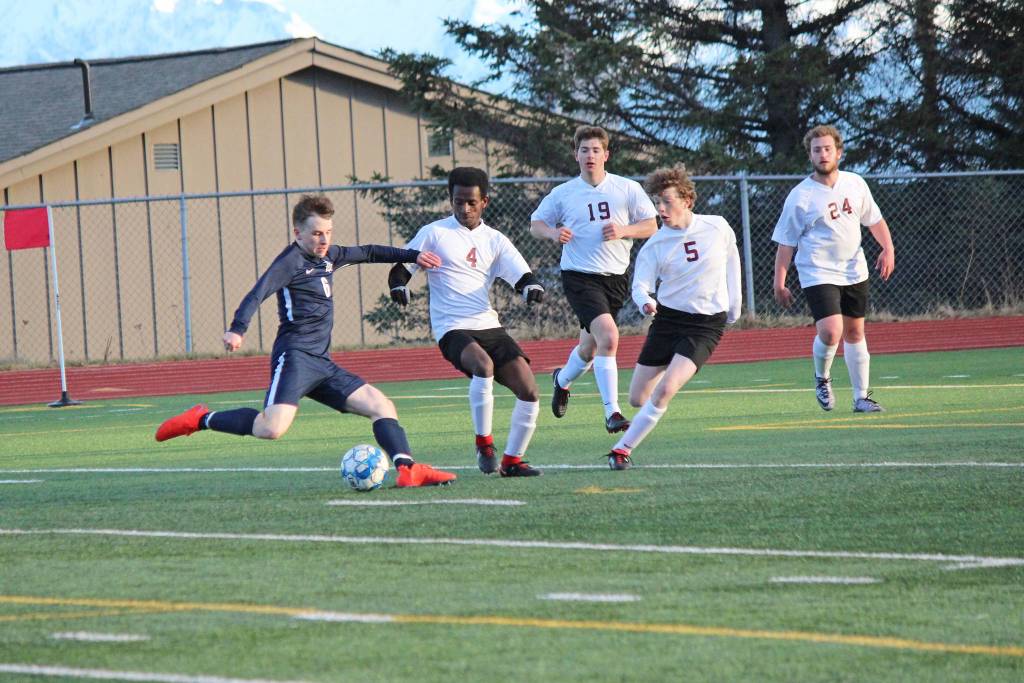 With five Grace Christian players closing in, Homer Mariner Tom Gorman, 6, keeps control of the ball during Fridays varsity game on April 26, 2019, at the high school in Homer, Alaska. (Photo by McKibben Jackinsky)