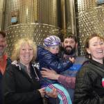 In March, Bear Creek Winery and Lodging founders Bill and Dorothy Fry, left, officially signed the business over to their son-in-law and daughter Louis and Jasmine Maurer, shown here with their two daughters, Maggie, 4, and Aurora, six months. They posed for a photo on April 17, 2019, at the winery in Kachemak City, Alaska. (Photo by McKibben Jackinsky)