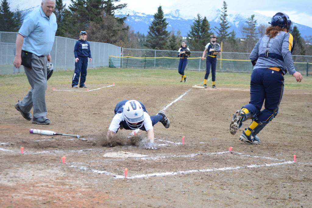 A SoHi softball player takes a dive for the plate in a game against the Homer High School Mariners on Tuesday, April 30, 2019, against Soldotna High School at Jack Gist Park in Homer, Alaska. (Photo by Michael Armstrong/Homer News)