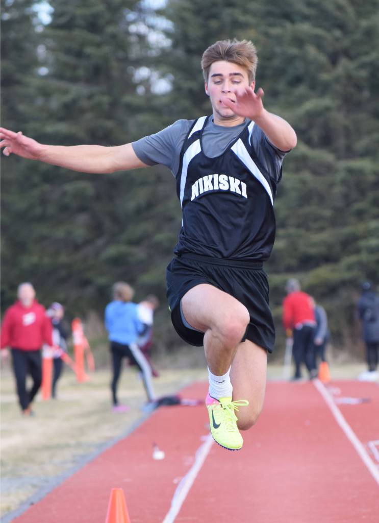 Nikiskis Garrett Ellis makes an attempt in the boys triple jump Saturday, May 4, 2019, at the Kenai Invitational track meet at Kenai Central High School. (Photo by Joey Klecka/Peninsula Clarion)