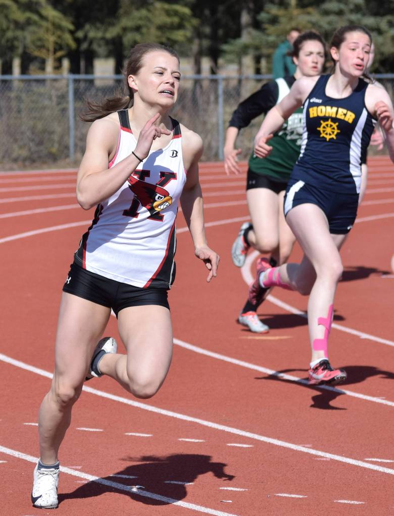 Kenais Hayley Maw rounds a turn ahead of Homers Laura Inama in the girls 200 meter final Saturday, May 4, 2019, at the Kenai Invitational track meet at Kenai Central High School. (Photo by Joey Klecka/Peninsula Clarion)