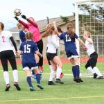 Kenai goal keeper Kailey Hamilton knocks the ball out of a pack of players during a Thursday, May 9, 2019 soccer game at Homer High School in Homer, Alaska. (Photo by Megan Pacer/Homer News)
