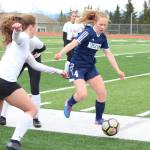Homers Jessica Sonnen rushes to the ball along with Kenais Abigail Schneiders during a Thursday, May 9, 2019 soccer game at Homer High School in Homer, Alaska. (Photo by Megan Pacer/Homer News)