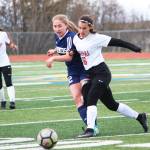 Homers Brenna McCarron makes a pass under pressure from Kenais Taylor Pierce during a Thursday, May 9, 2019 soccer game at Homer High School in Homer, Alaska. (Photo by Megan Pacer/Homer News)