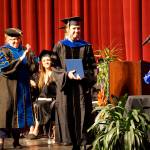 Emilie Springer smiles after receiving her doctor in anthropology degree and hood at the Kachemak Bay Campus commencement last Wednesday, May 8, 2019, at the Mariner Theatre in Homer, Alaska. Applauding at left is KBC interim campus director Paula Martin. A Homer resident from Ninilchik, Springer received her doctorate from the University of Alaska Fairbanks but chose to receive her PhD. in her home town  the first doctorate to do so at KBC commencement. (Photo by Michael Armstrong/Homer News.)