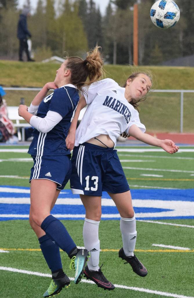 Homers Kappa Reutov (13) and Soldotnas Ryann Cannava jump up for a header Saturday, May 11, 2019, in a Peninsula Conference game in Soldotna, Alaska. (Photo by Joey Klecka/Peninsula Clarion)