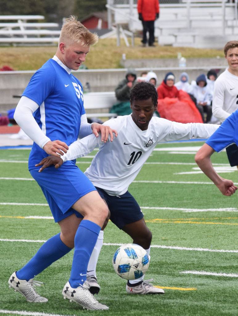 Soldotnas Hudson Metcalf (left) and Homers Eyoab Knapp battle for the ball Saturday, May 11, 2019, in a Peninsula Conference game in Soldotna, Alaska. (Photo by Joey Klecka/Peninsula Clarion)