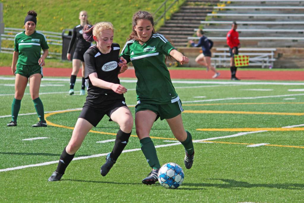 Nikiskis Cailin Yeager (left) and Sewards Belladonna Darby (right) battle for the ball during the first girls game of the Peninsula Conference Soccer Tournament on Thursday, May 16, 2019 at Homer High School in Homer, Alaska. (Photo by Megan Pacer/Homer News)