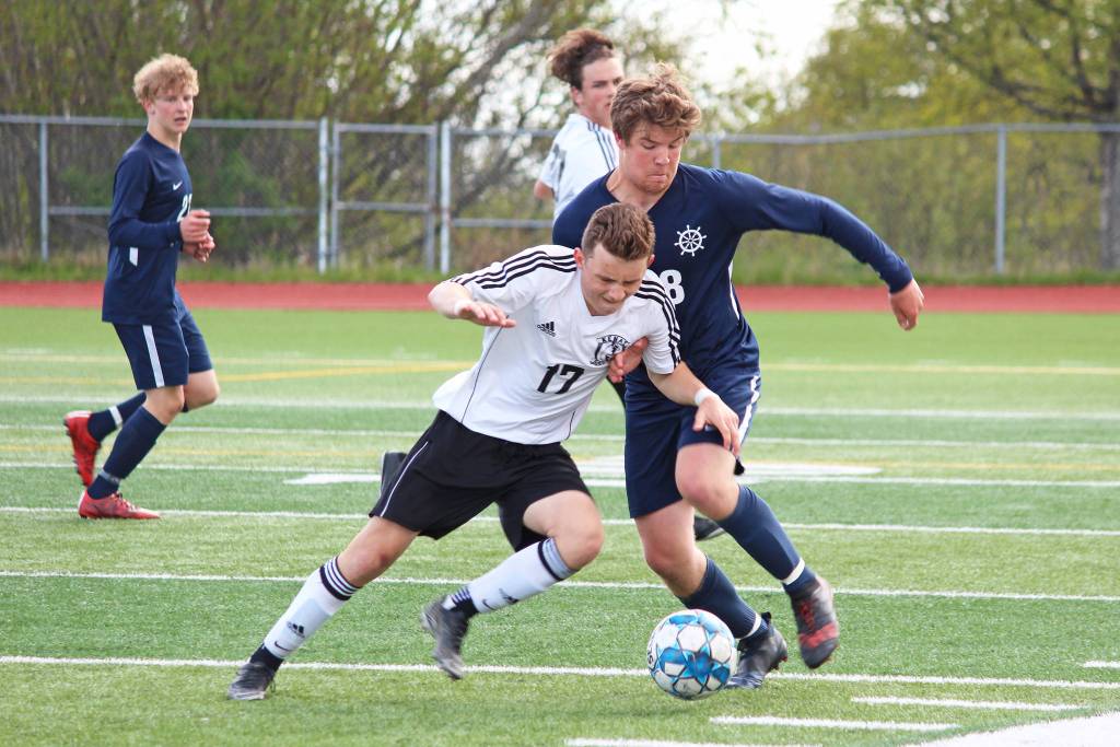 Homers Phinny Weston (right) and Kenais Travis Verkuilen battle for the ball during the championship boys soccer game of the Peninsula Conference Tournament on Saturday, May 18, 2019 at Homer High School in Homer, Alaska. The Mariners won 1-0. (Photo by Megan Pacer/Homer News)