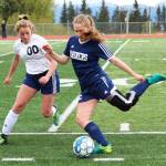 Homers Brenna McCarron (right) prepares to send the ball up the field under pressure from Soldotnas Ryann Cannava during the girls championship game of the Peninsula Conference Soccer Tournament on Saturday, May 18, 2019 at Homer High School in Homer, Alaska. (Photo by Megan Pacer/Homer News)