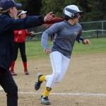 Mariner Haylee Owen rounds third base and keeps on going as Assistant Coach Hannah Zook directs her toward home plate.