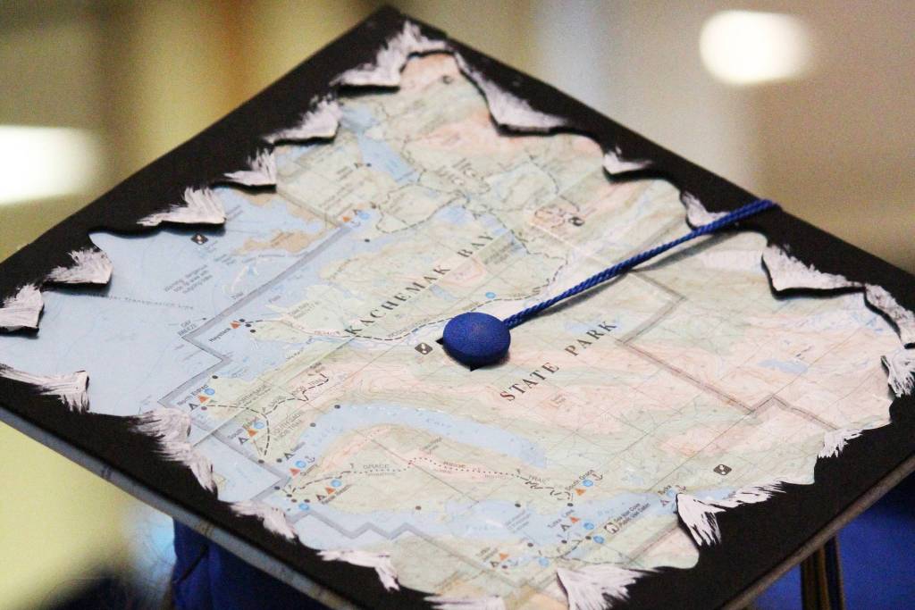 A Homer High School graduate waits for the graduation ceremony in her cap decorated with a map of Kachemak Bay on Wednesday, May 22, 2019 at the high school in Homer, Alaska. (Photo by Megan Pacer/Homer News)