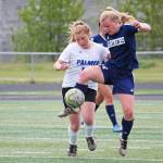 Homers Daisy Kettle battles for the ball with Palmers Avery Hill in a Friday, May 24, 2019 game during the Division II state soccer championship tournament at West Anchorage High School in Anchorage, Alaska. (Photo by Megan Pacer/Homer News)
