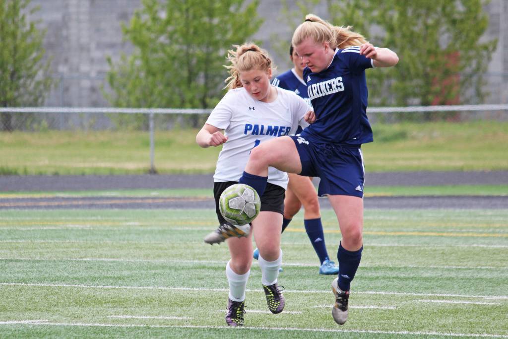 Homers Daisy Kettle battles for the ball with Palmers Avery Hill in a Friday, May 24, 2019 game during the Division II state soccer championship tournament at West Anchorage High School in Anchorage, Alaska. (Photo by Megan Pacer/Homer News)