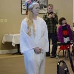 Samantha Martin walks in at the start of Flex School graduation ceremonies on Wednesday, May 22, 2019, at Lands End Resort in Homer, Alaska. Martin wore cowboy boots, and her hat read, Blame it all on my roots / I showed up in boots. (Photo by Michael Armstrong/Homer News)