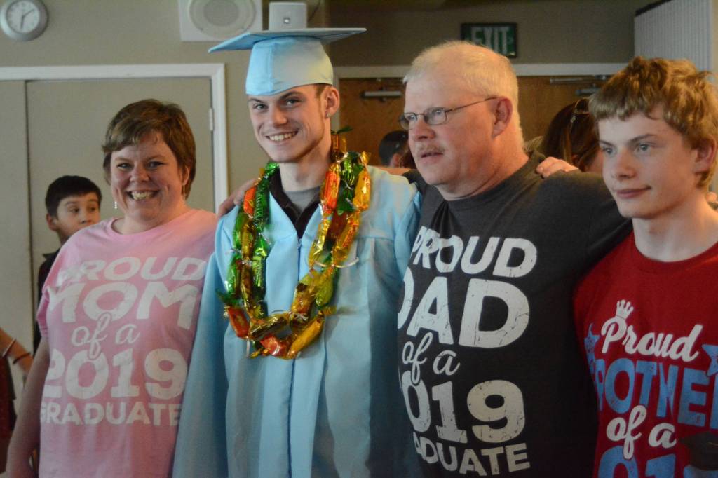 Graduate Sean Moran, second from left, poses with his family after at graduation ceremonies on Wednesday, May 22, 2019, at Lands End Resort in Homer, Alaska. At left is his mother, Amanda Moran, at far right is his brother, Joseph Moran, and second from right is his father, Donald Moran. (Photo by Michael Armstrong/Homer News)