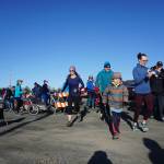 Runners and walkers participate in the Blue Line Run in Homer, Alaska, on March 30, 2019. They moved along the blue line, or the line marking the top of the 50-foot high inundation zone in the event of a tsunami. (Photo provided)