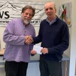 Homer News Editor Michael Armstrong, left, is presented with an award from Publisher Jeff Hayden on May 10, 2019 at the Homer News office in Homer, Alaska. (Photo by Malia Anderson)