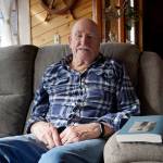 Sandy Mazen poses with a copy of his memoir, Kiyonuk, at his Homer, Alaska, home on April 22, 2019. (Photo by Michael Armstrong)