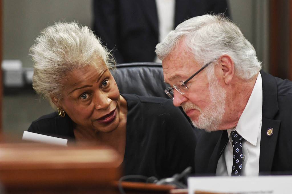 Sen. Elvi Gray-Jackson, D-Anchorage, speaks with Sen. Gary Stevens, R-Kodiak, at the Capitol on Monday, June 10, 2019. (Michael Penn | Juneau Empire)