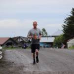 Jesse Hostetter runs through historic Ninilchik Village for the Clam Scramble held Saturday, June 15, 2019 in Ninilchik, Alaska. Begun in the mid 1800s, Ninilchik was established as a settlement for Russian American Company pensioners. Descendants of the the villages original families still live in the area. (Photo by McKibben Jackinsky)