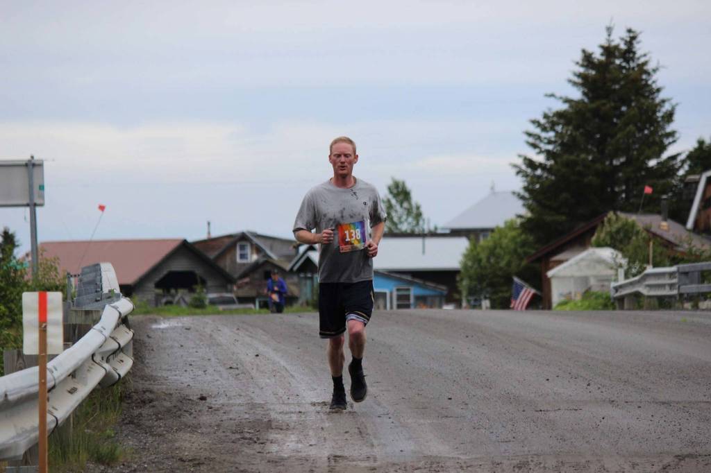Jesse Hostetter runs through historic Ninilchik Village for the Clam Scramble held Saturday, June 15, 2019 in Ninilchik, Alaska. Begun in the mid 1800s, Ninilchik was established as a settlement for Russian American Company pensioners. Descendants of the the villages original families still live in the area. (Photo by McKibben Jackinsky)