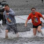 Jon Marsh, 107, and Mckenzie Lindeman, 222, dont let a little cold water slow them down in the Clam Scramble held Saturday June 15, 2019 on Ninilchik beach, Alaska. (Photo by McKibben Jackinsky)
