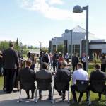 Alaska Gov. Mike Dunleavy, standing at podium, speaks at a news conference Friday, June 14, 2019, in Wasilla, Alaska. Dunleavy has called lawmakers into special session July 8 in Wasilla, and his administration gave a tour of the recommended site at Wasilla Middle School to reporters. (AP Photo/Mark Thiessen)