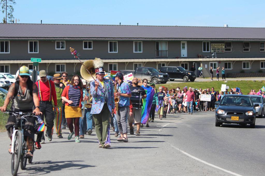 Participants in this years Pride Walk make their way up Ocean Drive on Saturday, June 22, 2019 in Homer, Alaska. (Photo by Megan Pacer/Homer News)