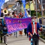 The New Old Time Chautauqua Fighting Instruments of Karma Marching Chamber Band Orchestra marches along the Homer Harbor on July 2, 2019, in Homer, Alaska. (Photo by Michael Armstrong/Homer News)