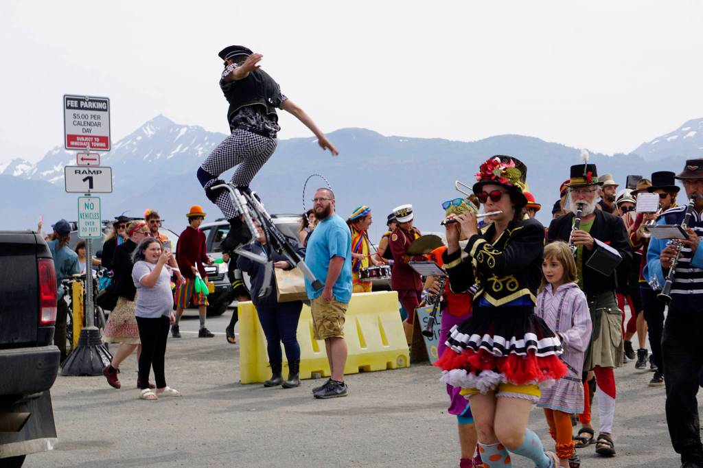 The New Old Time Chautauqua Fighting Instruments of Karma Marching Chamber Band Orchestra marches by the Salty Dawg on July 2, 2019, in Homer, Alaska. (Photo by Michael Armstrong/Homer News)