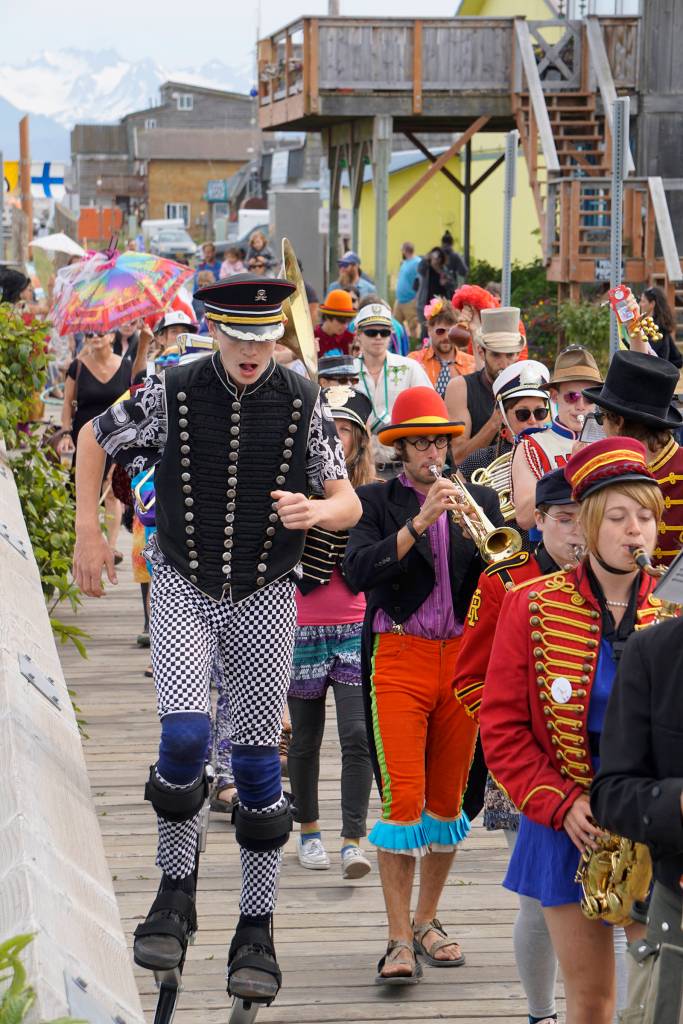 The New Old Time Chautauqua Fighting Instruments of Karma Marching Chamber Band Orchestra marches along the Homer Harbor on July 2, 2019, in Homer, Alaska. (Photo by Michael Armstrong/Homer News)
