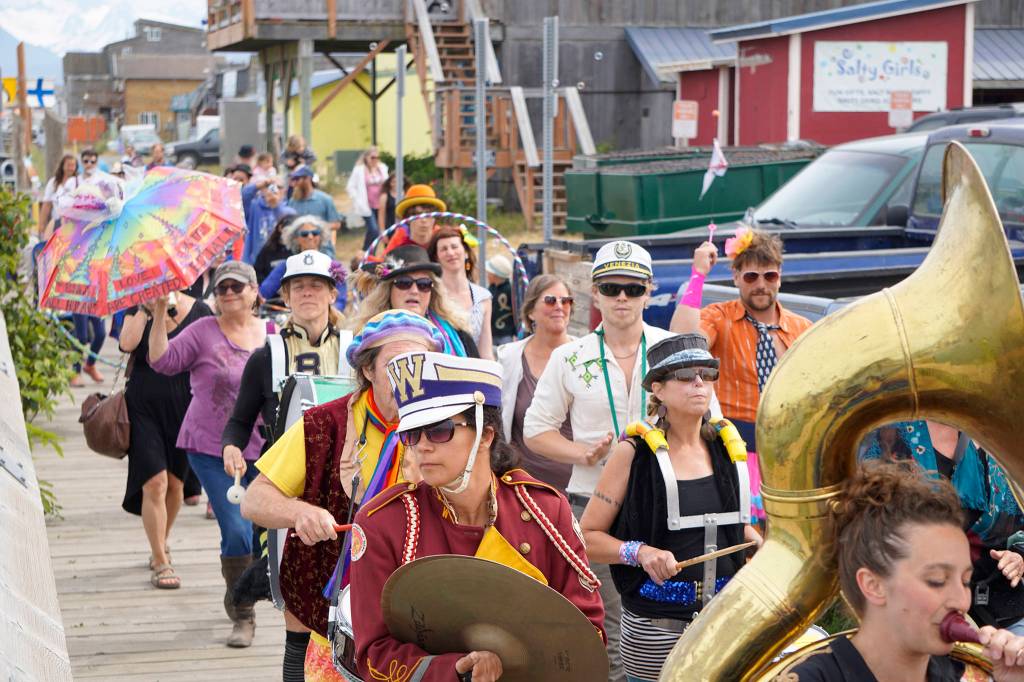 The New Old Time Chautauqua Fighting Instruments of Karma Marching Chamber Band Orchestra marches along the Homer Harbor on July 2, 2019, in Homer, Alaska. (Photo by Michael Armstrong/Homer News)