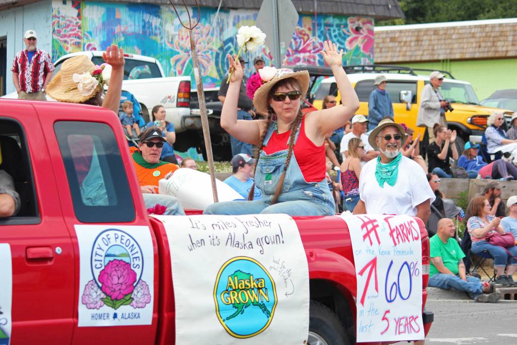 Homer Farmers Market Director Robbi Mixon celebrates on a float in this years July Fourth parade, hosted by the Homer Chamber of Commerce, on Thursday, July 4, 2019 on Pioneer Avenue in Homer, Alaska. (Photo by Megan Pacer/Homer News)