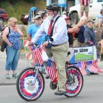 Homer Mayor Ken Castner cycles down Pioneer Avenue during this years July Fourth parade, hosted by the Homer Chamber of Commerce, on Thursday, July 4, 2019 in Homer, Alaska. (Photo by Megan Pacer/Homer News)