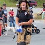 A member of Kachemak Emergency Services smiles as she throws candy to spectators at this years July Fourth parade.