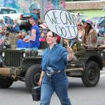 A woman dressed as Rosie the Riveter marches in the July Fourth parade hosted by the Homer Chamber of Commerce on Thursday, July 4, 2019 on Pioneer Avenue in Homer, Alaska. (Photo by Megan Pacer/Homer News)