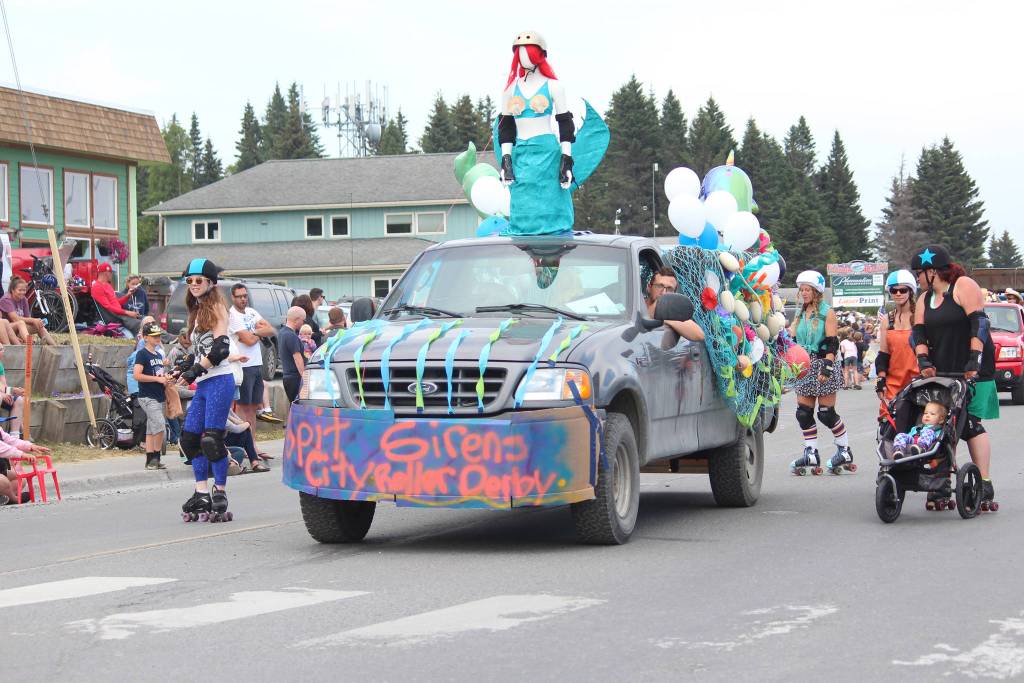 Members of the Spit City Sirens roller derby team make their way down Pioneer Avenue in this years July Fourth parade hosted by the Homer Chamber of Commerce on Thursday, July 4, 2019 in Homer, Alaska. (Photo by Megan Pacer/Homer News)