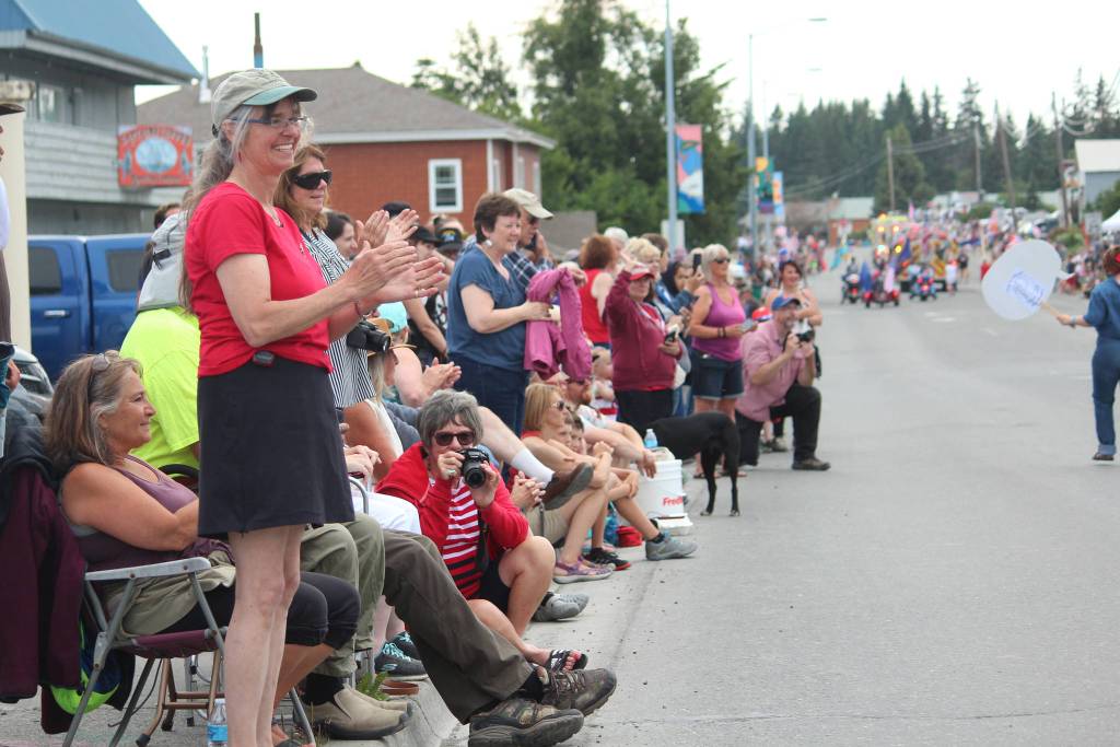 Onlookers cheer on participants in this years July Fourth parade hosted by the Homer Chamber of Commerce on Thursday, July 4, 2019 on Pioneer Avenue in Homer, Alaska. (Photo by Megan Pacer/Homer News)