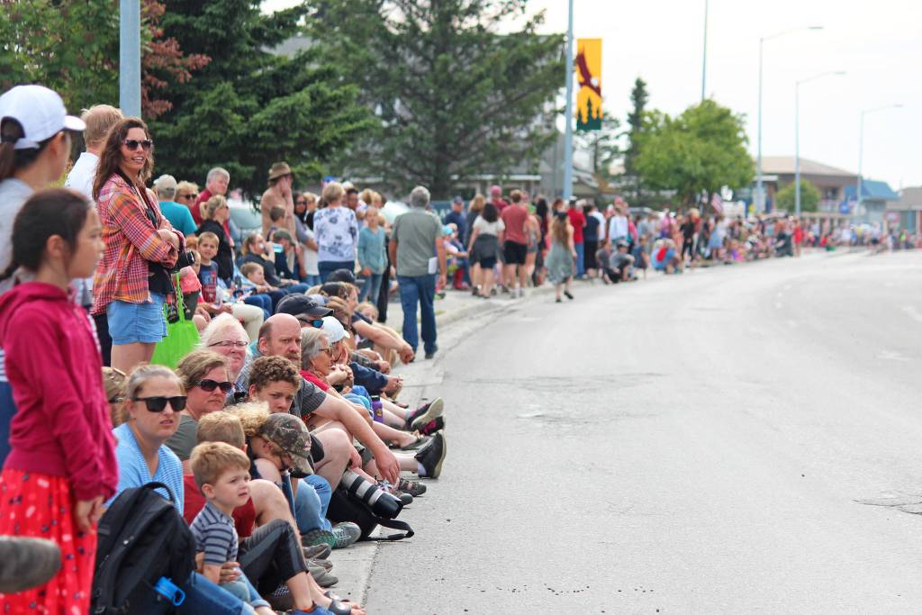 People line Pioneer Avenue wait in anticipation of this years July Fourth parade on Thursday, July 4, 2019 in Homer, Alaska. (Photo by Megan Pacer/Homer News)