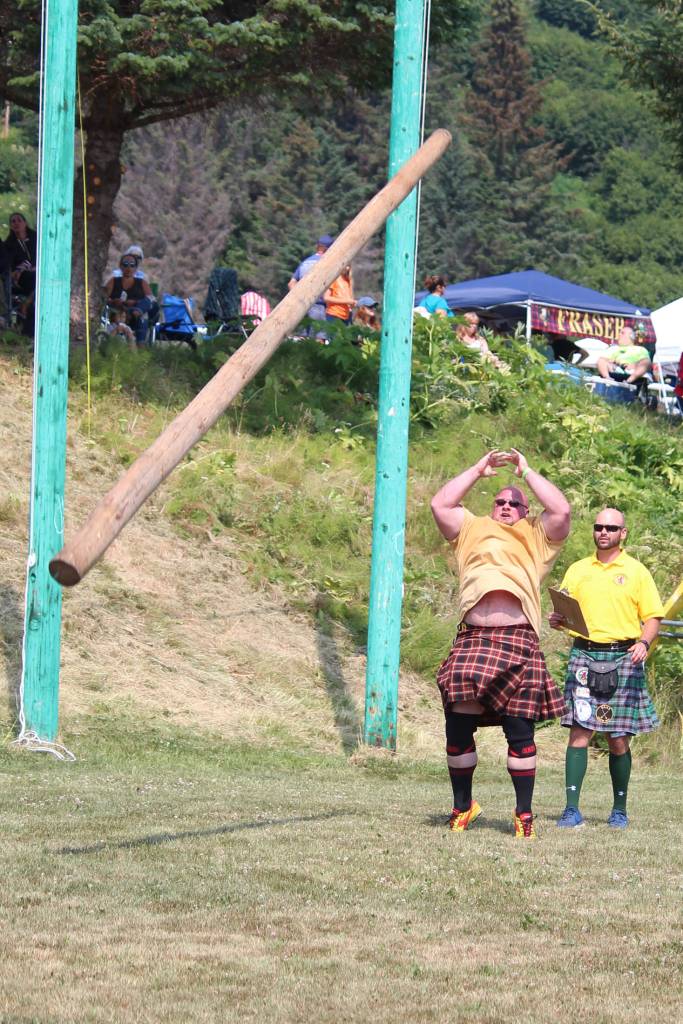 Robert Moody throws a caber while a judge looks on during the mens caber toss event at this years Kachemak Bay Highland Games on Saturday, July 6, 2019 at Karen Hornaday Park in Homer, Alaska. (Photo by Megan Pacer/Homer News)