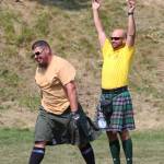 A judge throws his arms into the air to indicate that Danny Autrey, left, earned a perfect score in the mens caber toss by throwing the caber so that it flipped once and landed in the 12 oclock position, or directly in front of the athlete, on Saturday, July 6, 2019 at Karen Hornaday Park in Homer, Alaska. Autrey took first place in the Mens Open class at the annual Kachemak Bay Highland Games held there. (Photo by Megan Pacer/Homer News)