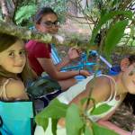 Grands Marguerite Vallee, Cecilia Fitzpatrick and Genevieve Vallee seek shade, solace, companionship and Doritos under the lilacs on the Fourth of July in the Kachemak Gardeners garden. (Photo by Rosemary Fitzpatrick)