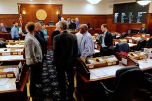 Lawmakers talk among themselves during a break of a joint session of the Alaska Legislature Thursday, July 11, 2019, in Juneau, Alaska. Lawmakers are meeting for a second day to consider overriding Gov. Mike Dunleavys budget vetoes, but still dont have the needed 45 votes as about a third of lawmakers continue to meet in Wasilla instead of Juneau. (Michael Penn/The Juneau Empire via AP)