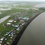 This Wednesday, June 26, 2019 photo shows an aerial view of the Yupik village of Stebbins on the Norton Sound coast in Western Alaska. The city is among over a dozen cities in Alaska that have employed police officers whose criminal records should have prevented them from being hired under state law, the Anchorage Daily News and ProPublica reported Saturday, July 20. (Bill Roth/Anchorage Daily News via AP)