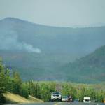 A plume of smoke rises from the Swan Lake fire area as vehicles head south on the Sterling Highway on July 18, 2019, near Skilak Lake, Alaska. (Photo by Michael Armstrong/Homer News)