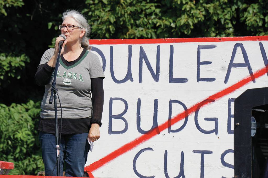 Teresa Sundmark speaks about support the University of Alaska at a rally Sunday, July 28, 2019, against Gov. Mike Dunleavys budget cuts at the Legislative Information Office, Homer, Alaska. (Photo by Michael Armstrong/Homer News).