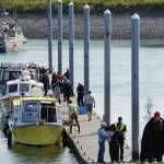Emergency medical technicians help victims of a boat capsizing up the Homer Harbor load and launch ramp on Tuesday afternoon, July 30, 2019, in Homer, Alaska. Crews in three Good Samaritan boats, from front to back, the Torega, the Grotta Nove, and the Seabird, rescued five people from an overturned skiff near China Poot Bay. (Photo by Michael Armstrong/Homer News)